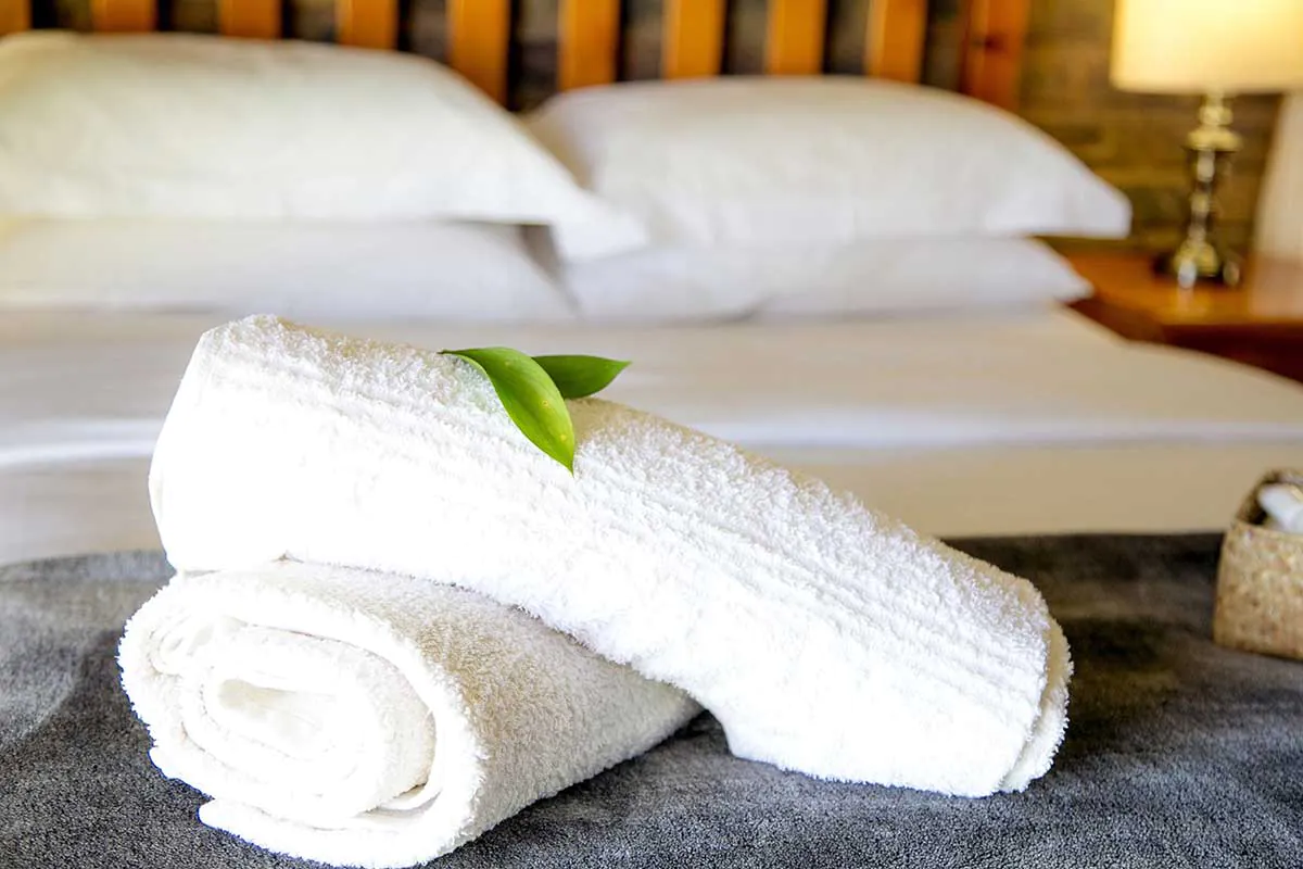 a pair of white towels on a bed