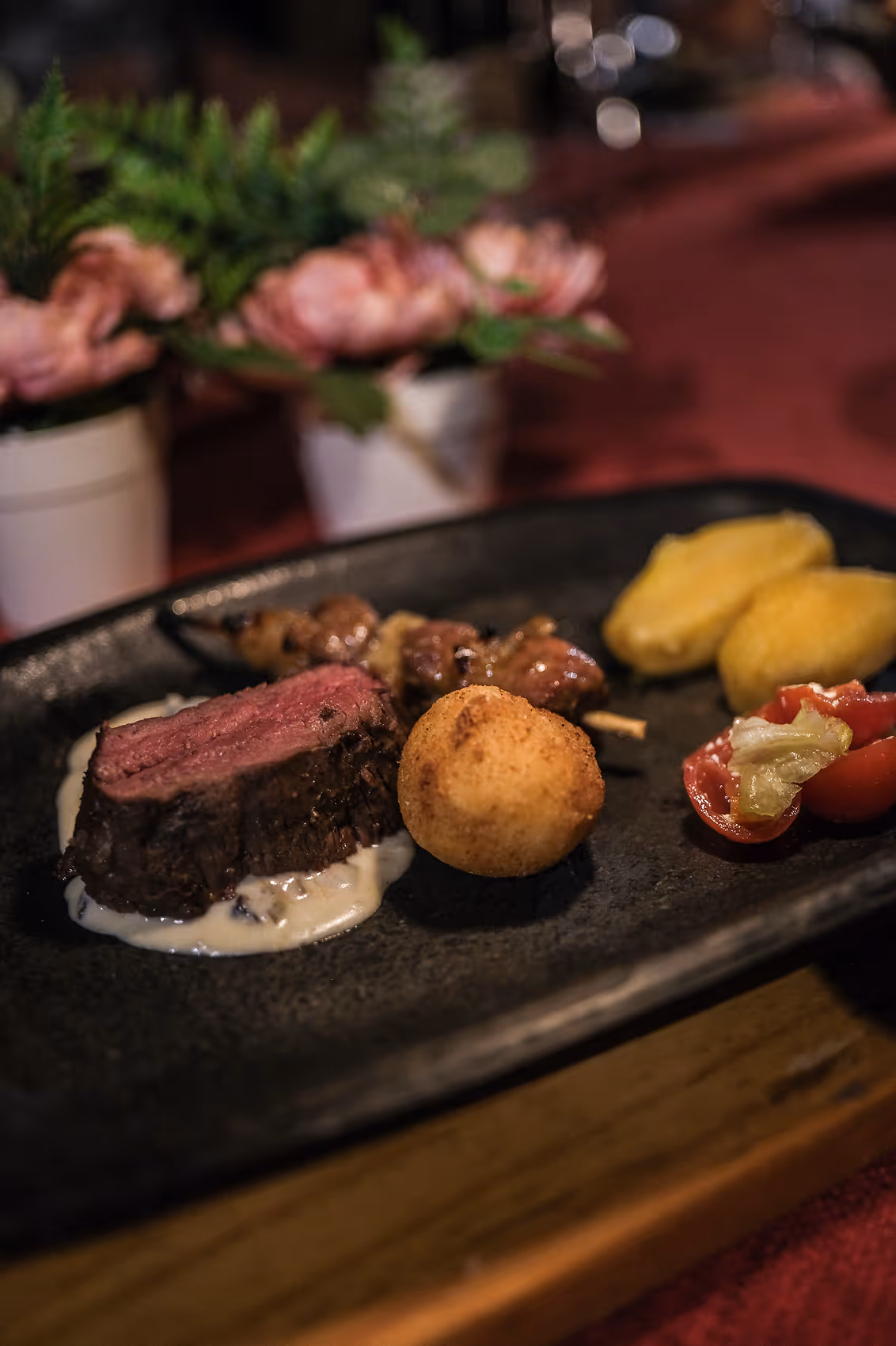 Plated meal with medium-rare steak and traditional sides